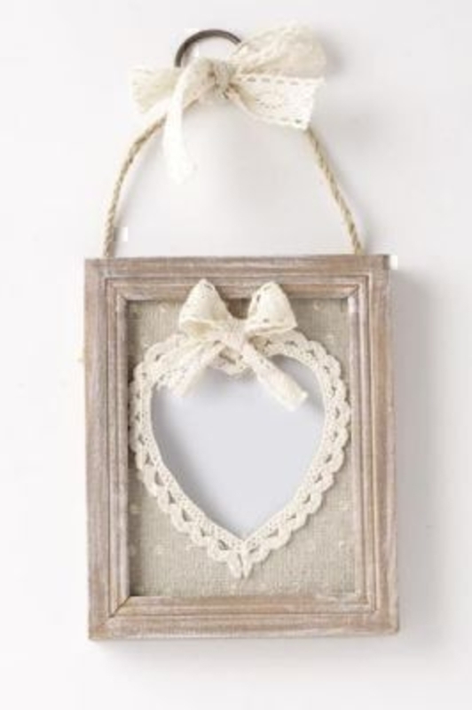 Wooden Frame with Lace Heart by Heaven Sends. Small shabby chic wooden frame with hessian mounting and lace around the aperture. Rope hanger with metal ring and lace bow at top. Size 15x12x1.5cm Hold photo size 10x8cm